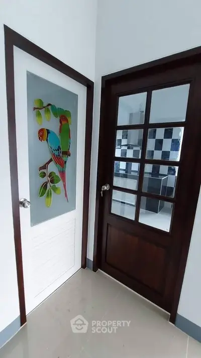 Stylish interior doors with vibrant parrot design and glass panel in modern home.