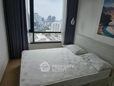Modern bedroom with city view, featuring large window and minimalist decor in urban apartment.