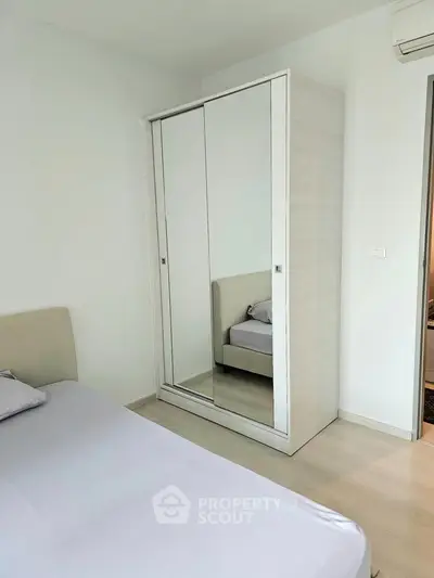 Modern bedroom with mirrored wardrobe and minimalist design