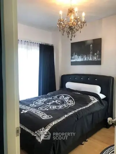 Elegant bedroom with chandelier and stylish decor