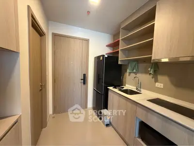 Modern kitchen with sleek cabinetry and black appliances in a stylish apartment