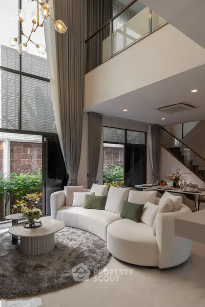 Luxurious modern living room with high ceilings and elegant decor