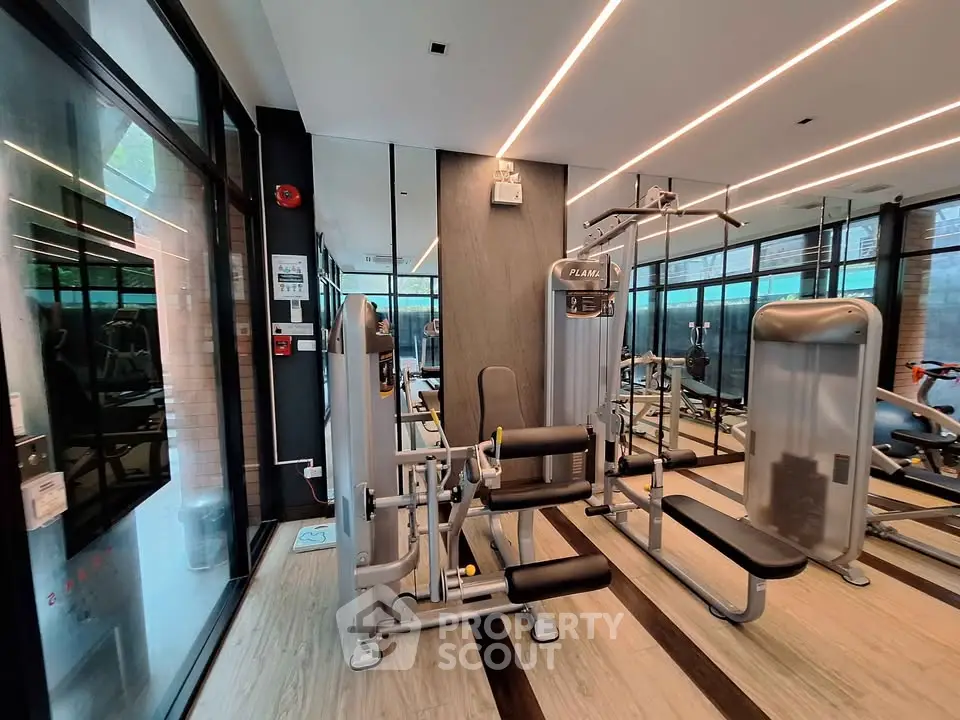 Modern gym with state-of-the-art fitness equipment and floor-to-ceiling windows