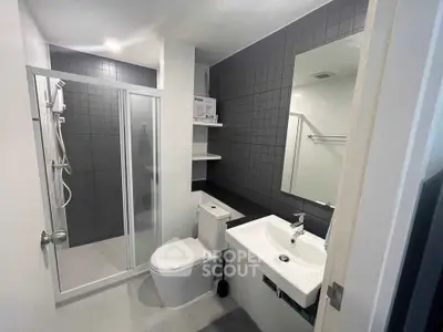 Modern bathroom with sleek shower and stylish fixtures in contemporary apartment.