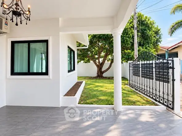 Charming home exterior with spacious patio and lush garden view.