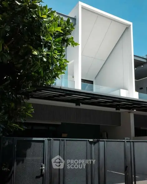 Modern architectural home exterior with sleek design and lush greenery