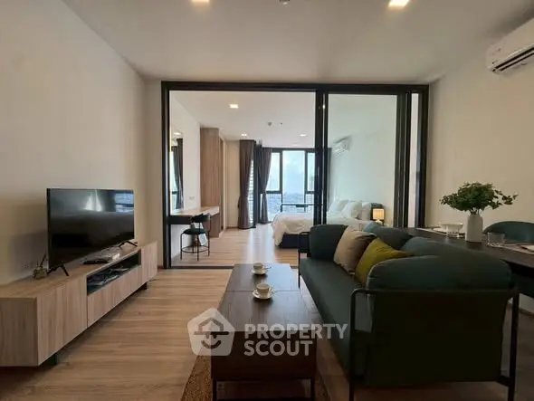 Modern open-plan living room with stylish furniture and large windows offering a stunning view.