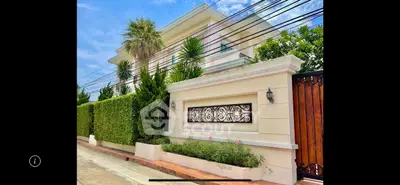 Luxurious villa exterior with lush greenery and elegant design in a prime location.