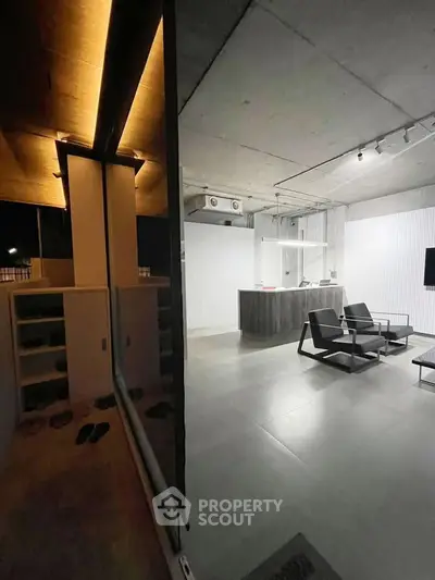 Modern industrial-style living room with sleek furniture and ambient lighting.