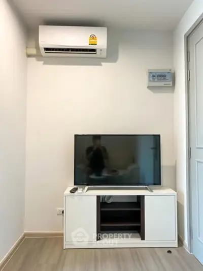 Modern living room with air conditioning and sleek TV setup