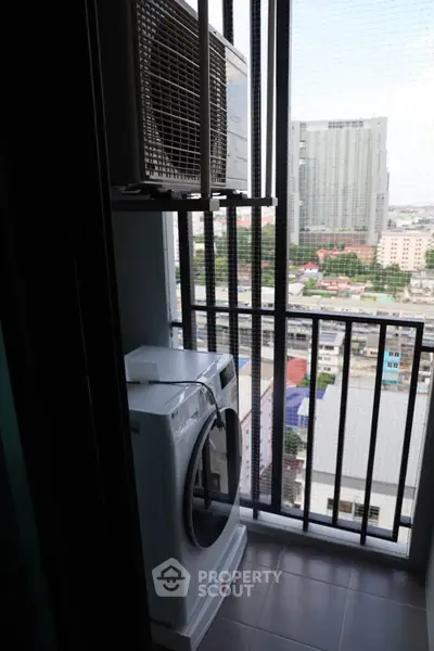High-rise apartment balcony with washing machine and city view