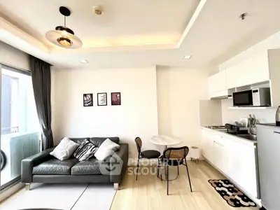 Modern living room with open kitchen, stylish decor, and natural light