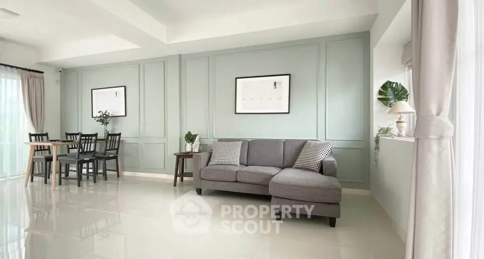 Spacious living room with elegant decor and natural light, perfect for modern living.