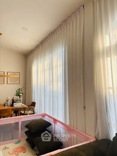 Cozy living room with soft lighting and elegant curtains, perfect for relaxation.