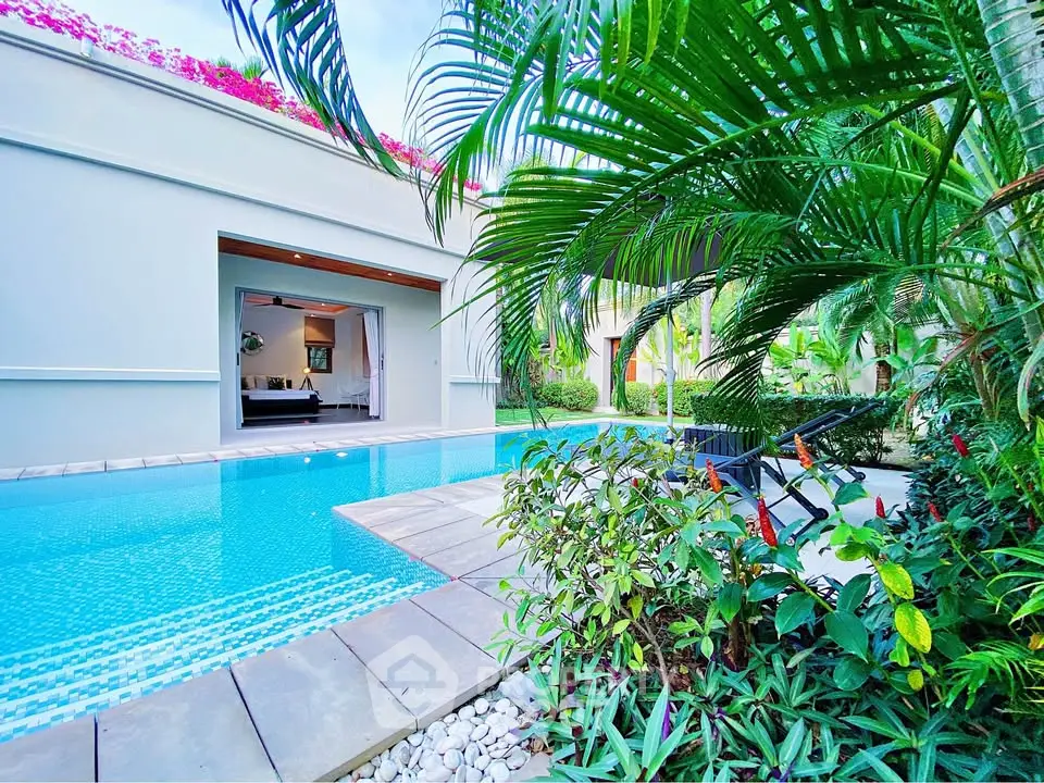 Luxurious poolside view with lush greenery and modern architecture, perfect for relaxation and entertainment.