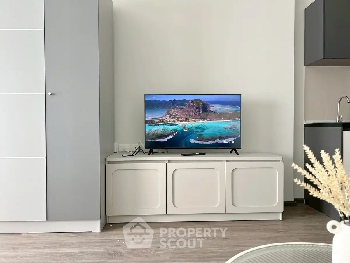 Modern living room with sleek TV setup and stylish cabinetry