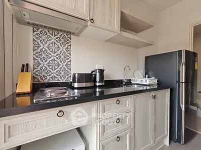 Modern kitchen with sleek black countertop and stainless steel appliances