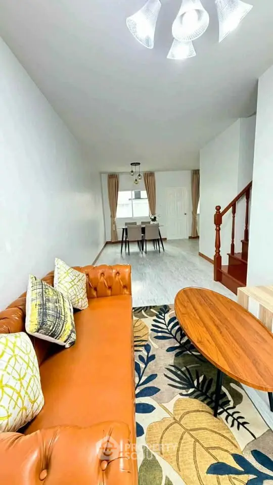 Spacious living room with stylish decor and modern lighting in a cozy home setting.