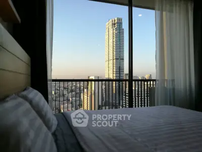 Luxurious bedroom with stunning city view from high-rise apartment