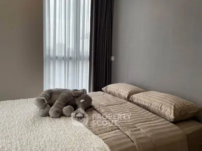 Cozy bedroom with elegant decor and plush elephant toy on bed