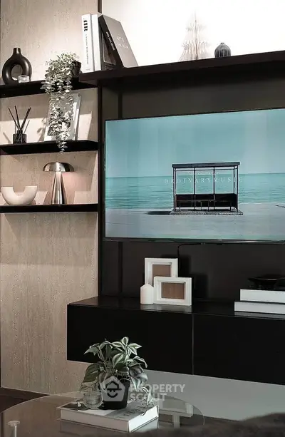 Modern living room with stylish shelving and flat-screen TV displaying serene ocean view.