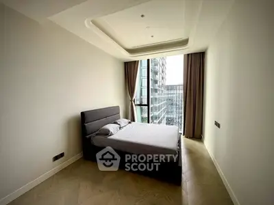 Modern bedroom with large window and city view in luxury apartment