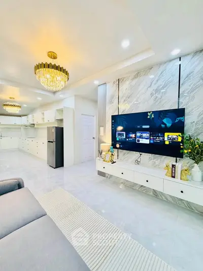 Luxurious modern living room with elegant chandeliers and sleek marble accents.