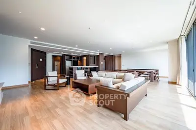 Spacious modern living room with open layout and elegant wooden flooring.