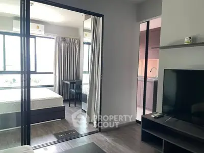 Modern apartment interior with bedroom and living area, featuring large windows and sleek design.