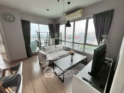 Modern living room with city view, stylish decor, and ample natural light.