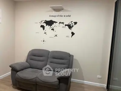 Cozy living room with world map wall art and plush gray sofa