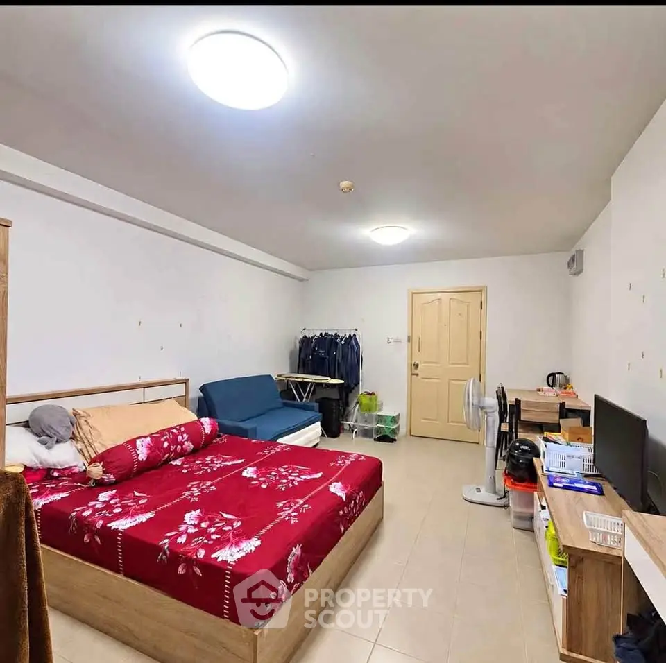 Spacious bedroom with modern furnishings and ample lighting