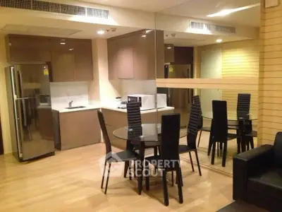 Modern kitchen and dining area with sleek design and mirrored wall