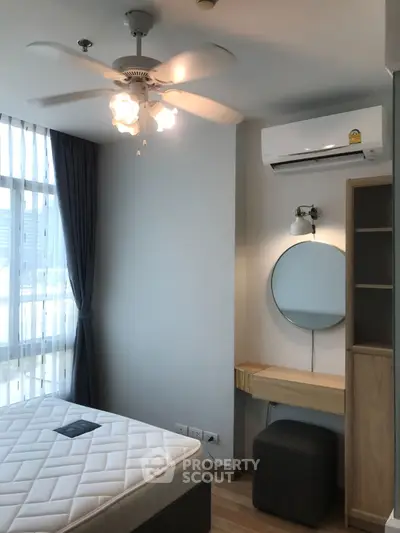 Modern bedroom with ceiling fan, air conditioning, and stylish furniture.