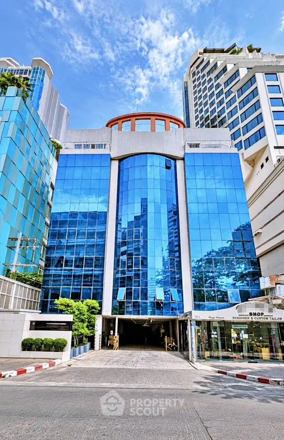 Stunning modern building with reflective glass facade in urban setting, showcasing contemporary architecture.