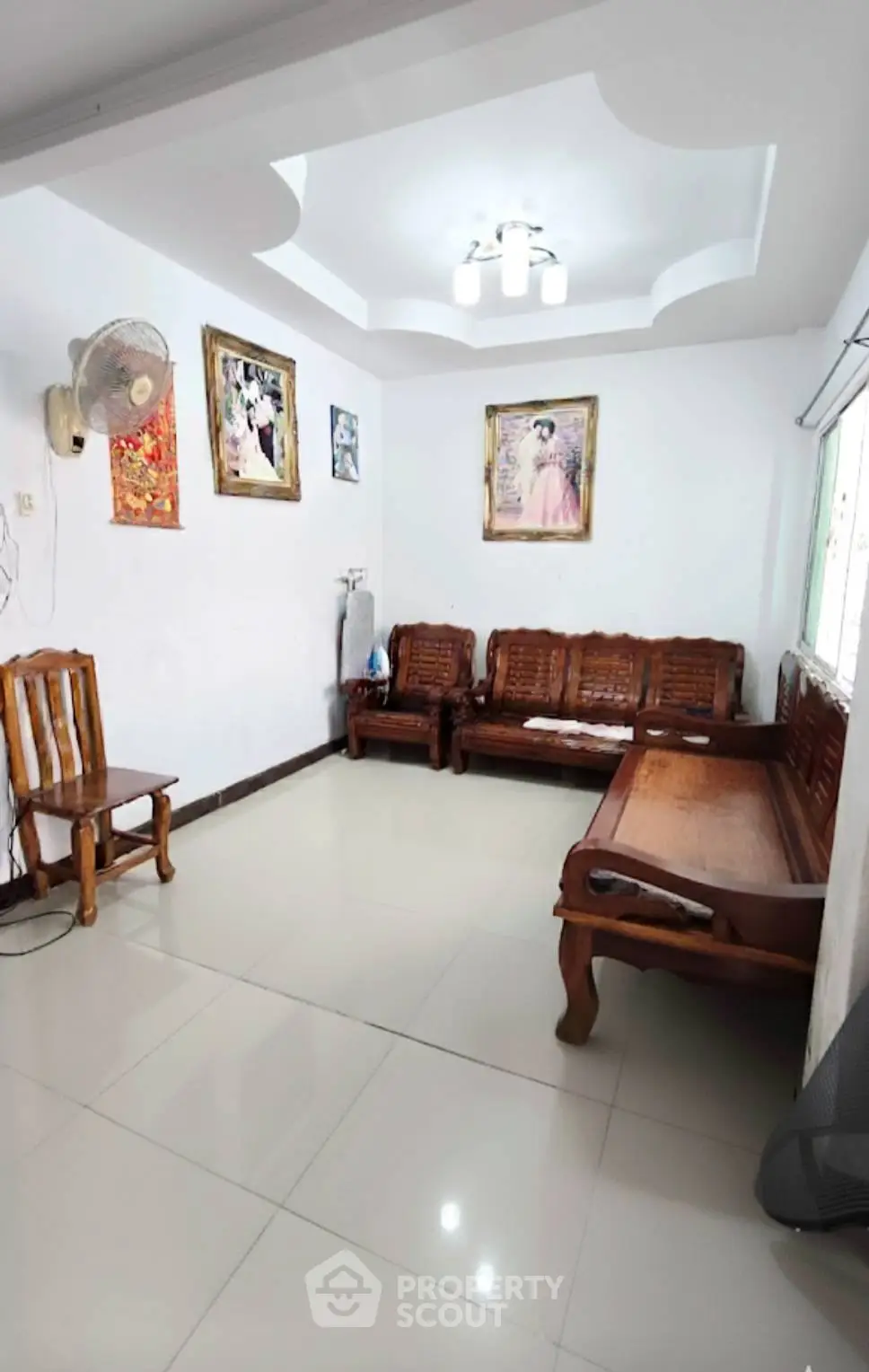 Spacious living room with wooden furniture and elegant ceiling design
