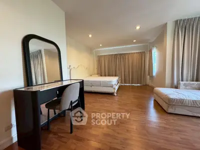 Spacious bedroom with elegant decor and large windows for natural light