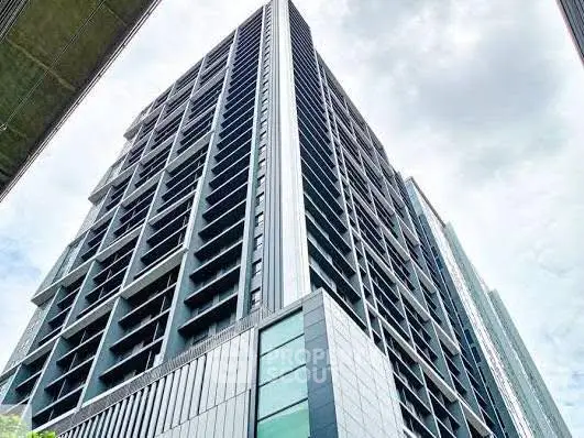 Modern high-rise building with sleek architectural design and large windows.