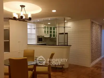 Stylish open-layout kitchen with modern dining area and elegant lighting