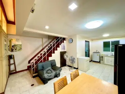 Spacious open-plan living area with modern kitchen and cozy seating, perfect for family gatherings.