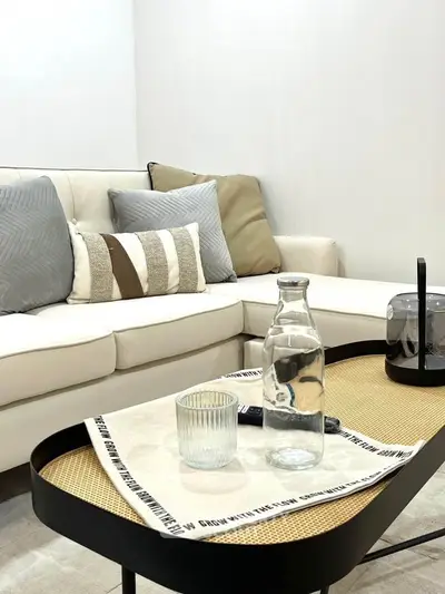 Stylish modern living room with cozy sofa and elegant coffee table setup.