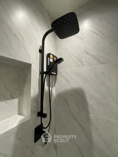 Modern bathroom with sleek black shower fixture and marble tiles
