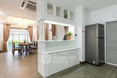 Elegant dining room with modern kitchen and stylish decor in a spacious open layout.