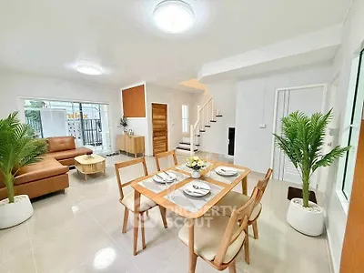 Spacious modern living and dining area with elegant decor and natural light.