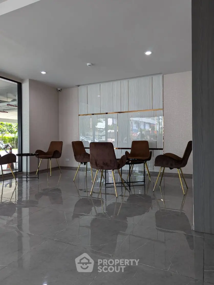 Modern lobby area with stylish seating and large windows offering natural light.