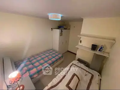 Cozy bedroom with twin beds and modern lighting, ideal for small spaces.