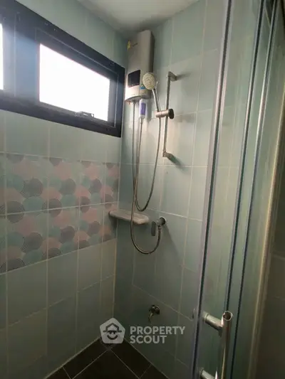 Modern bathroom with stylish tiles and shower fixtures