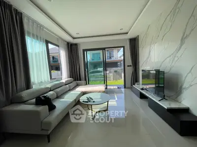 Modern living room with large windows and stylish furniture