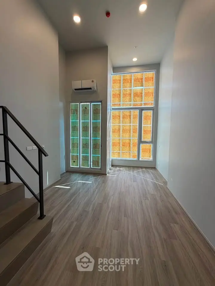 Spacious modern living room with high ceilings and large windows