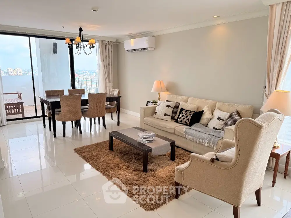 Spacious living room with elegant decor and city view balcony